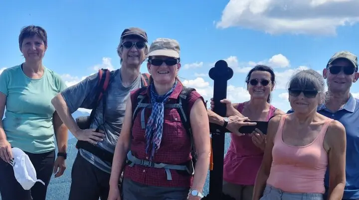 Sechs Wanderer auf dem Gipfel des Fockenstein mit Bergpanorama und blauem Himmel | © DAV Sektion Geltendorf